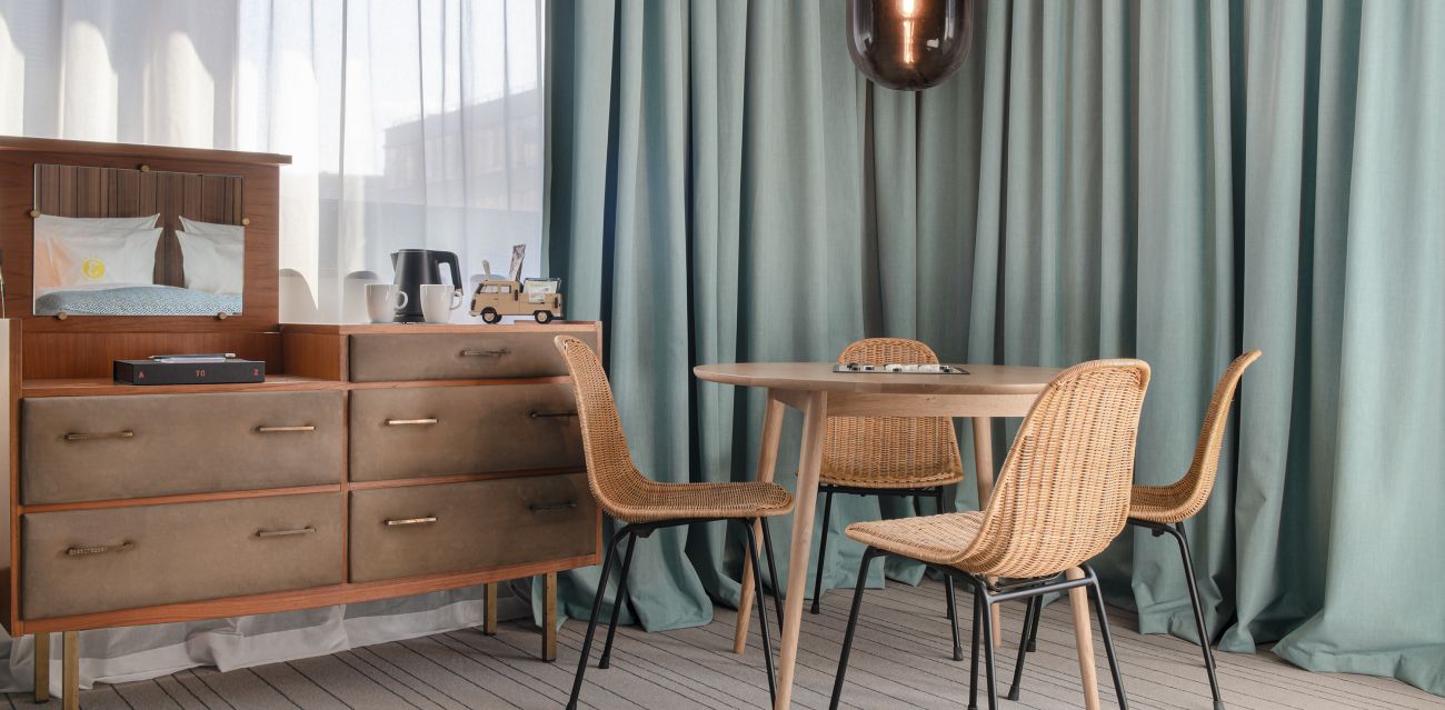 Bed with TV, large table for playing games and a chest of drawers in an EXTRA LARGE room