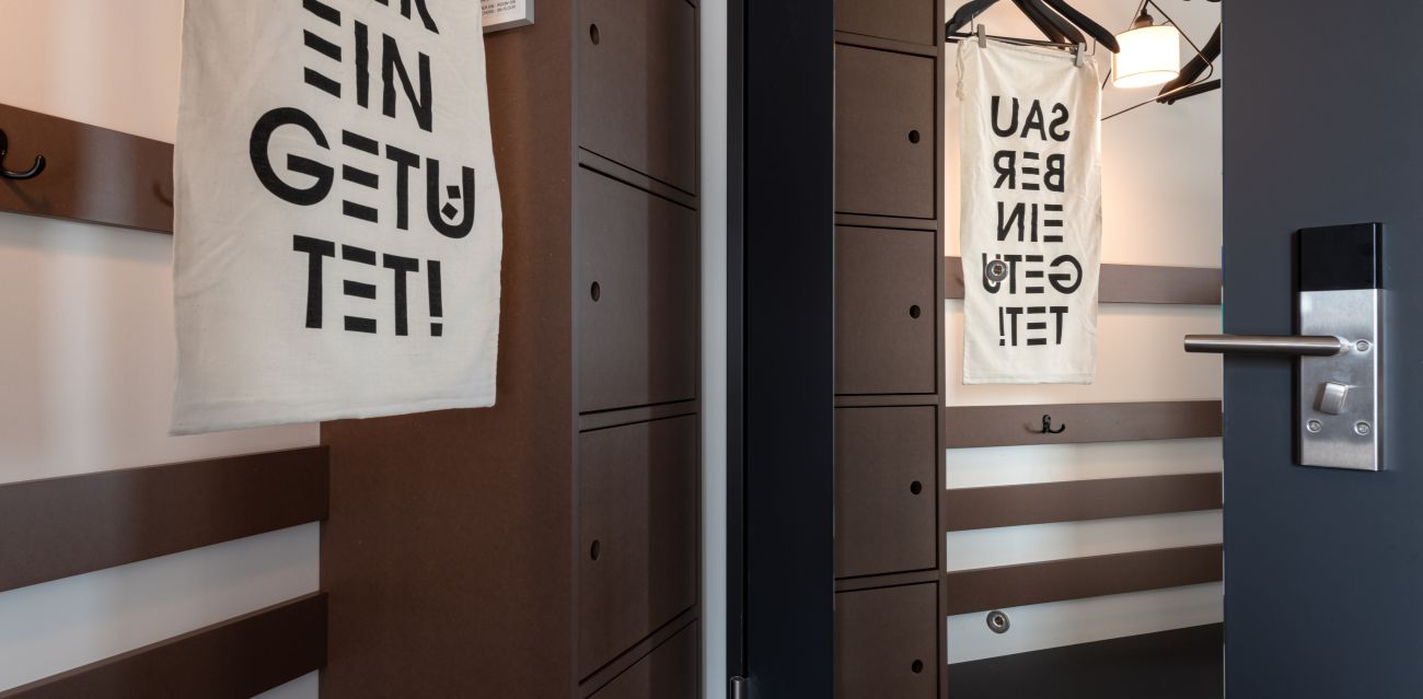 Close-up of the storage area in a room reflected in the mirror on the door