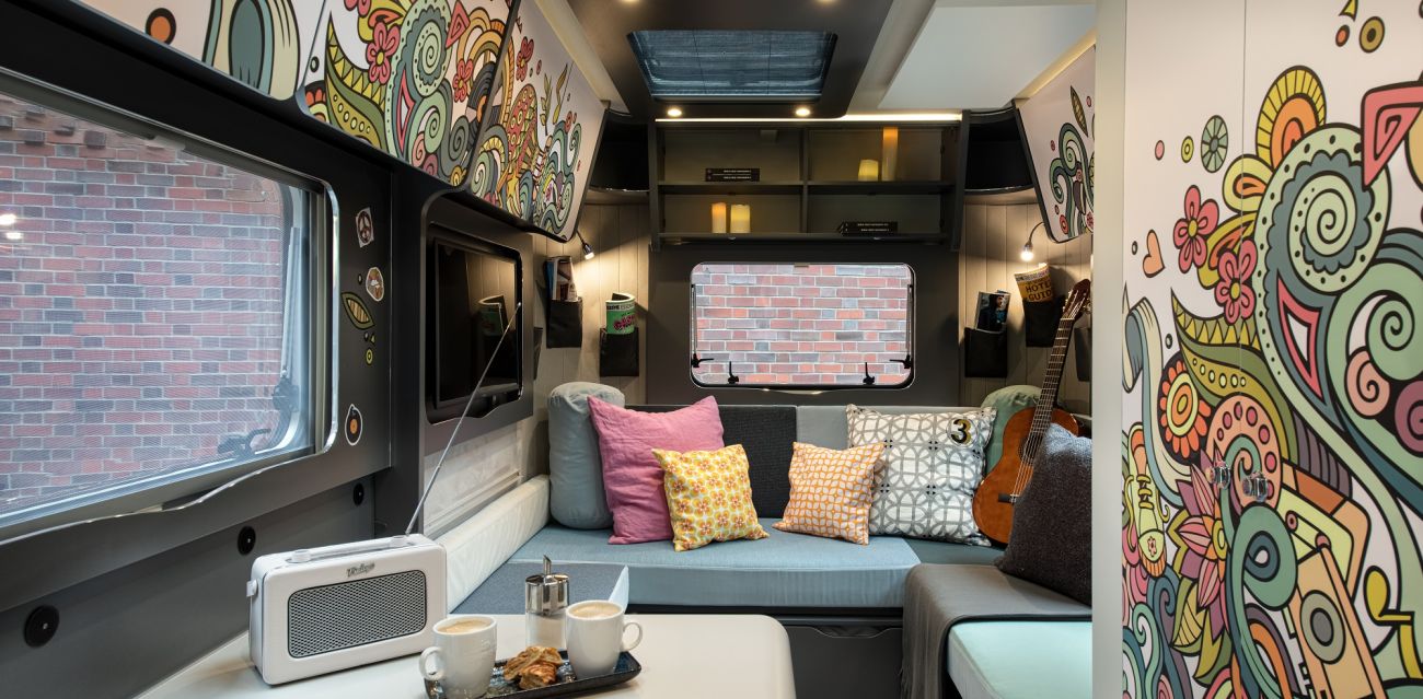 View of table and chill lounge in caravan HIPPIE